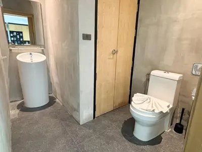 a bathroom with a toilet and a sink at Design Duplex Pavillion 2 BR Natural Park P11 in Kamala Beach