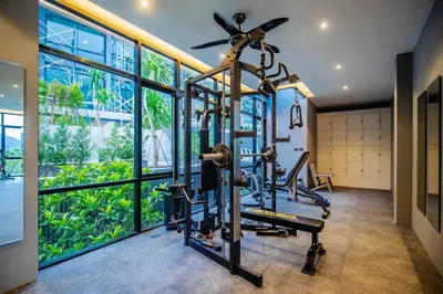 a gym with two tread machines and a large window at Design Duplex Pavillion 2 BR Natural Park P11 in Kamala Beach