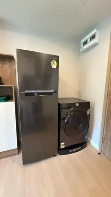 a refrigerator and a microwave in a room at Space Cherngtalay Condo in bangtao by sahana in Bang Tao Beach