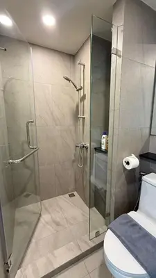 a bathroom with a glass shower with a toilet at Space Cherngtalay Condo in bangtao by sahana in Bang Tao Beach