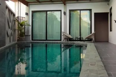 a swimming pool in the middle of a house at Holiday Villa M9 with Private Pool, 300m Rawai beach in Phuket Town