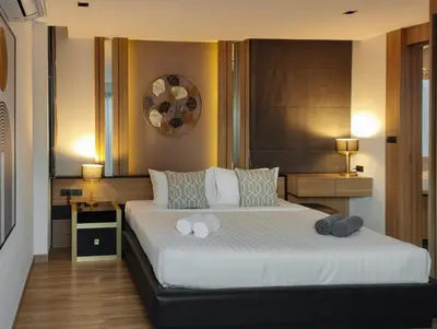 a bedroom with a bed with two pillows on it at Holiday Villa M9 with Private Pool, 300m Rawai beach in Phuket Town