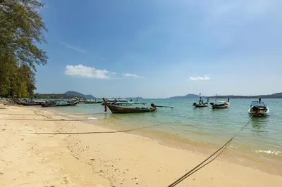 a group of boats in the water on a beach at Holiday Villa M9 with Private Pool, 300m Rawai beach in Phuket Town