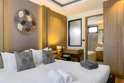 a hotel room with a bed and a bathroom at Tropical villa Sweet Dreams R20, Private Pool, Rawai Beach in Phuket Town