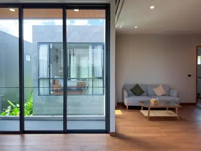 a living room with a couch and a table at Luxury 3-Bedroom Pool Villa Long One B9 with Panoramic Chalong Bay View in Ban Bo Rae