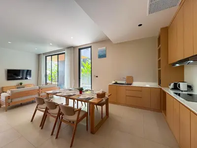 a kitchen and dining room with a table and chairs at Luxury 3-Bedroom Pool Villa Long One B9 with Panoramic Chalong Bay View in Ban Bo Rae