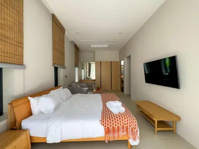 a bedroom with a large bed and a television at Luxury 3-Bedroom Pool Villa Long One B9 with Panoramic Chalong Bay View in Ban Bo Rae