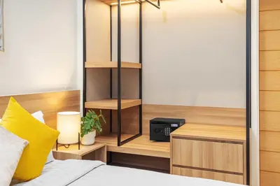 a bedroom with a bed and a book shelf at Laguna Lakeside BangTao Phuket in Bang Tao Beach