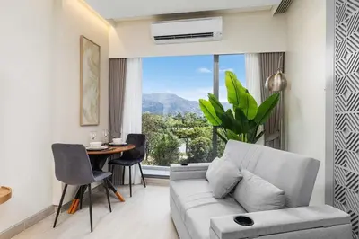 a living room with a couch and a table at Laguna Lakeside BangTao Phuket in Bang Tao Beach