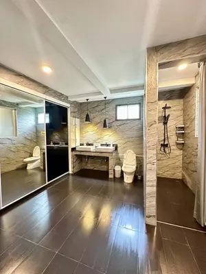 a large bathroom with a toilet and a sink at The White House Kamala II in Kamala Beach