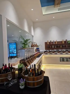 a wine store with bottles of wine on a counter at Kora Beach Resort Phuket in Bang Tao Beach