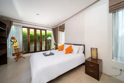 a bedroom with a white bed and a large window at Tropical Pool Villa Thai-modern Villa with an OFFICE in Phuket Town