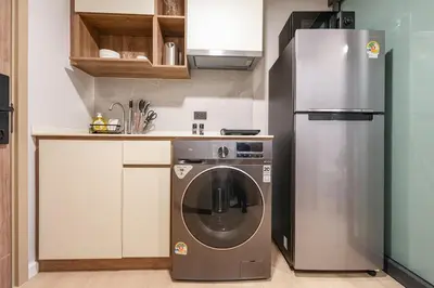 a kitchen with a stainless steel refrigerator and a dishwasher at New condo near the sea, Laguna, Choeng Thale 324 in Ban Thalat Choeng Thale
