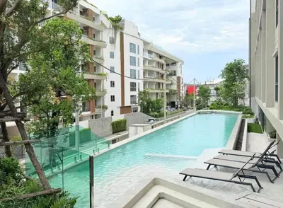 a swimming pool in the middle of a building at New condo near the sea, Laguna, Choeng Thale 324 in Ban Thalat Choeng Thale