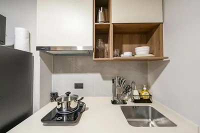 a kitchen counter with a sink and a stove at New condo near the sea, Laguna, Choeng Thale 324 in Ban Thalat Choeng Thale