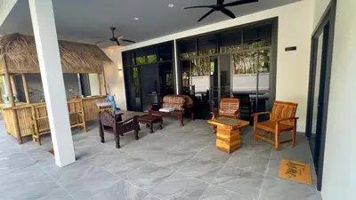 a living room with chairs and tables and a room at NEW! Welcome ! Villa - 3 bedroom 3 Baths - Ao Nang area in Ban Khao Klom