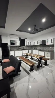 a large kitchen with a wooden table and a couch at NEW! Welcome ! Villa - 3 bedroom 3 Baths - Ao Nang area in Ban Khao Klom