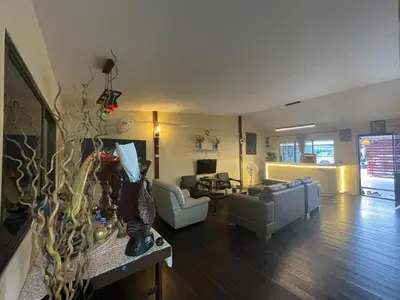 a living room with a couch and a table at Fisherman's house on stilts Phuket Old Town in Ban Tha Khreng