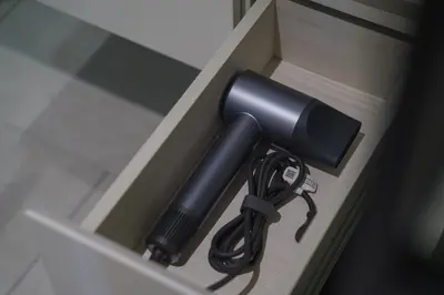 a flashlight sticking out of a cabinet door at The Title Legendary Elegant Suite Bangtao in Ban Thalat Choeng Thale