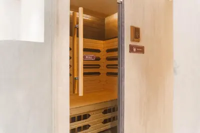 a door leading into a wine cellar with a wooden wine rack at The Title Legendary Elegant Suite Bangtao in Ban Thalat Choeng Thale