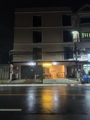 a building on the side of a street at night at The Nap House Phuket Town in Phuket Town