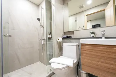 a bathroom with a toilet and a sink and a shower at New Condo Boat Avenue Modern Loft 325 in Ban Thalat Choeng Thale