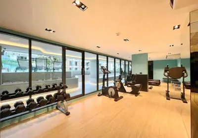 a gym with a person laying on the floor at New Condo Boat Avenue Modern Loft 325 in Ban Thalat Choeng Thale