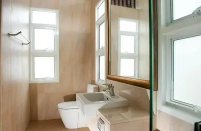 a bathroom with a toilet and a sink and windows at Luxury Phuket Pool Villa in Ban Saiyuan (1)