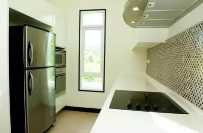 a kitchen with a stainless steel refrigerator and a window at Luxury Phuket Pool Villa in Ban Saiyuan (1)