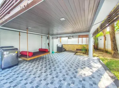 a porch with a bench and a tv in it at Luxury Phuket Pool Villa in Ban Saiyuan (1)
