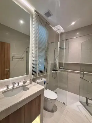 a bathroom with a toilet and a glass shower at Lili House Phuket in Ban Na Nai