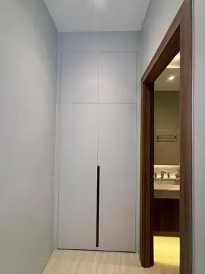a white closet in a bathroom with a sink at Lili House Phuket in Ban Na Nai
