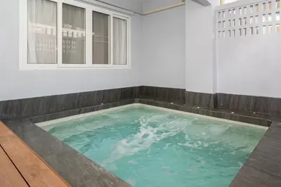 a large swimming pool in a room with a wooden floor at 3BR pool at Bangla Patong reach beach in 5m walk in Patong Beach
