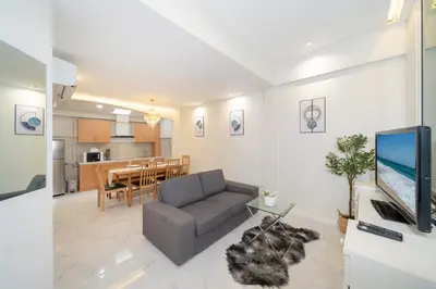 a living room with a couch and a dining room at 3BR pool at Bangla Patong reach beach in 5m walk in Patong Beach