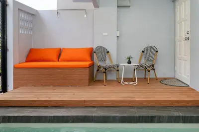 an orange bed with two chairs and a table at 3BR pool at Bangla Patong reach beach in 5m walk in Patong Beach