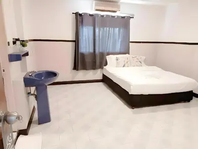 a small room with a bed and a sink at XX Mitr Inn - ภูเก็ต เมืองเก่า Phuket Old Town 2 in Phuket Town