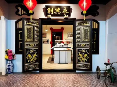 an open door into a room with a kitchen at XX Mitr Inn - ภูเก็ต เมืองเก่า Phuket Old Town 2 in Phuket Town