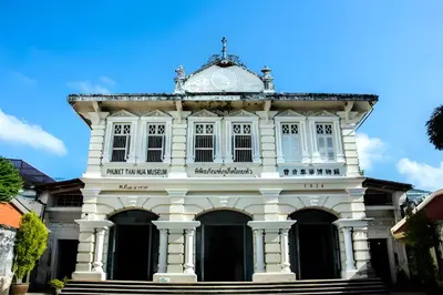 an old white building with a clock on top at XX Mitr Inn - ภูเก็ต เมืองเก่า Phuket Old Town 2 in Phuket Town