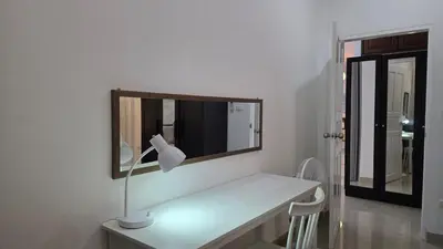 a white room with a mirror and a lamp on a table at Naiharn Beach Holiday Villa 2, Rawai Phuket in Rawai Beach