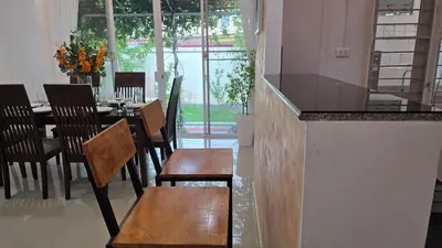 a restaurant with a table and chairs and a counter at Naiharn Beach Holiday Villa 2, Rawai Phuket in Rawai Beach