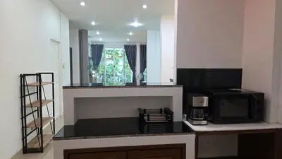 a kitchen with a microwave and a counter top with a microwave at Naiharn Beach Holiday Villa 2, Rawai Phuket in Rawai Beach