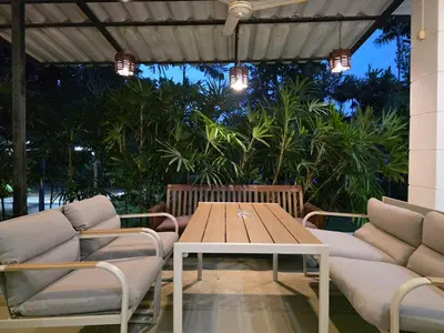 a patio with a wooden table and two chairs at Naiharn Beach Holiday Villa 2, Rawai Phuket in Rawai Beach