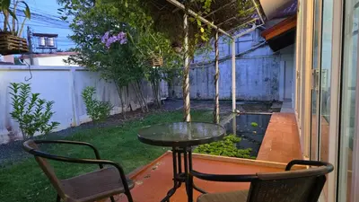 a table and two chairs on a patio at Naiharn Beach Holiday Villa 2, Rawai Phuket in Rawai Beach