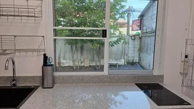 a kitchen with a large window and a sink at Naiharn Beach Holiday Villa 2, Rawai Phuket in Rawai Beach