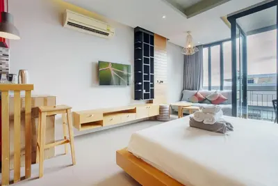 a bedroom with a bed and a desk and a couch at 405 Relife 5 Minutes Walk To Nai Harn Beach in Rawai Beach