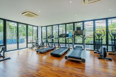 a gym with several treadmills and elliptical machines at 405 Relife 5 Minutes Walk To Nai Harn Beach in Rawai Beach