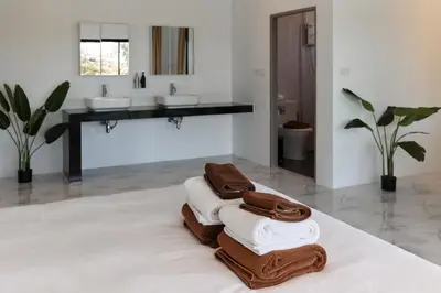 a bathroom with two sinks and two towels at Modern Villa 4-BR, Breeze - 10 min walk to NaiYang beach in Nai Yang Beach