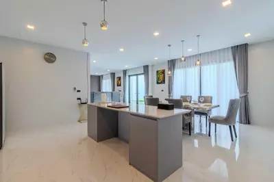 a kitchen and dining room with a table and chairs at 4BR Big Pool 2 Villas Same Land Near Nai Harn V258 in Rawai Beach