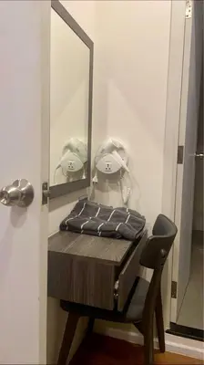 a dressing table with a mirror and a chair at The Central Escape Phuket in Ban Rangeng
