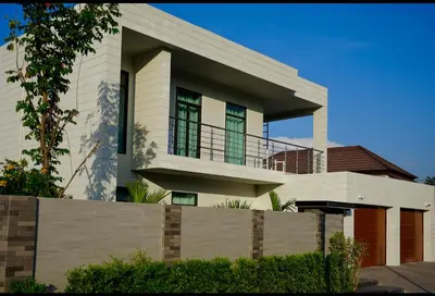 a white house with a fence in front of it at Villa Sofia in Ban Phak Chit